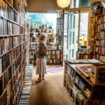 woman inside library looking at books